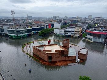 High angle view of river amidst buildings in city