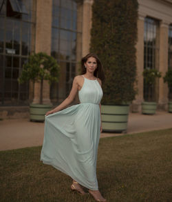 Portrait of young woman standing in park