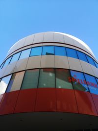 Low angle view of modern building against blue sky