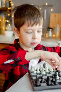 Boy plays chess. favorite hobby is chess.