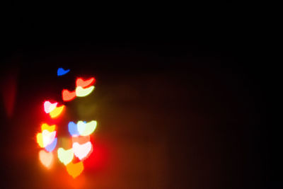 Close-up of road sign at night
