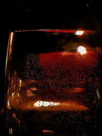 Close-up of wet car window at night