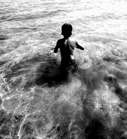 Full length of boy swimming in sea