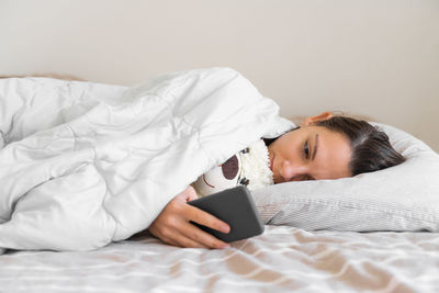 Young woman sleeping on bed at home