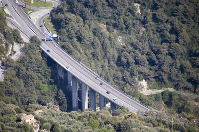 High angle view of bridge over road amidst trees