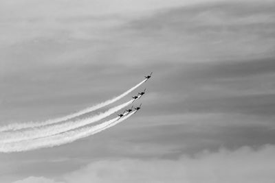 Low angle view of airplane flying against sky