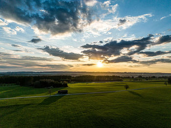 Scenic view of field against sky during sunset