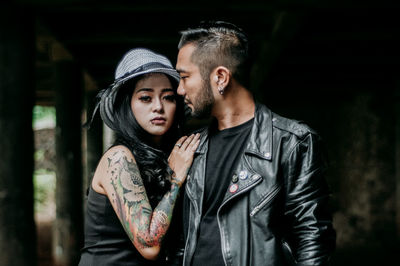 Portrait of young couple standing outdoors