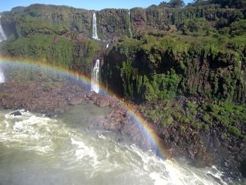 Scenic view of rainbow over river in forest