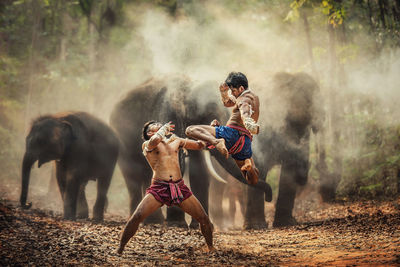 Full length of shirtless man lying on land