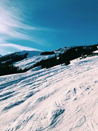 Scenic view of snowcapped mountains against blue sky