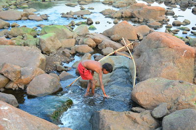 Man with fishing net on beach