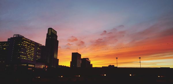 Low angle view of silhouette buildings against sky during sunset