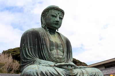 Low angle view of statue against sky