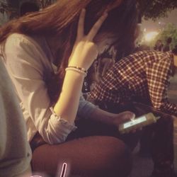 Midsection of woman using mobile phone