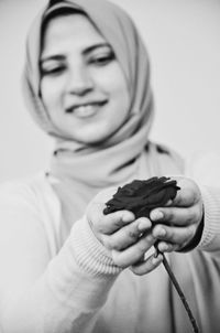 Close-up of woman holding rose flower