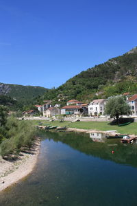 Houses in town against clear sky