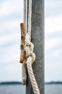 Close-up of rope tied on wooden post