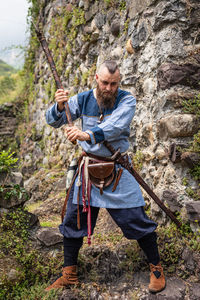 Full length of man holding rock