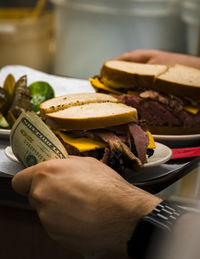 Cropped hand of person holding food