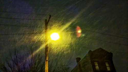 Low angle view of illuminated street light at night