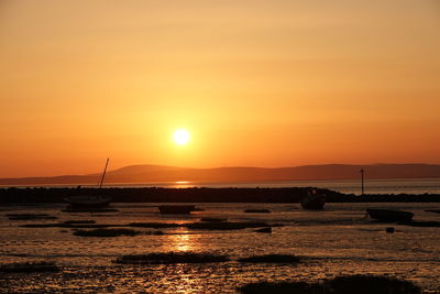 Scenic view of sea against orange sky