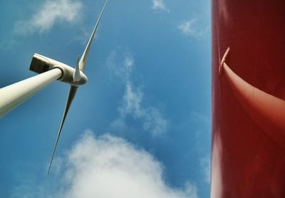 Low angle view of windmill against blue sky