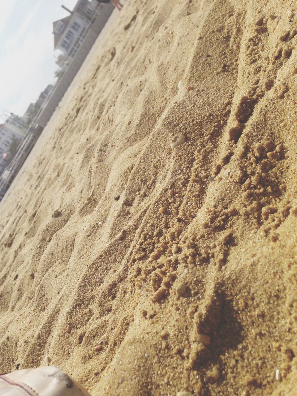 sand, beach, sunlight, day, sky, nature, outdoors, shadow, built structure, shore, sunny, architecture, footprint, tranquility, building exterior, high angle view, no people, textured, desert, sea