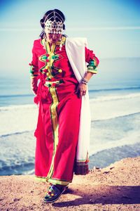 Full length of woman wearing traditional clothing at beach