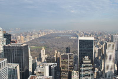 Aerial view of buildings against sky on sunny day