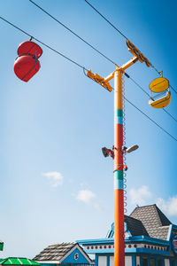 Low angle view of lanterns hanging against sky