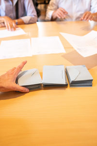 Cropped hand of person holding envelope at office