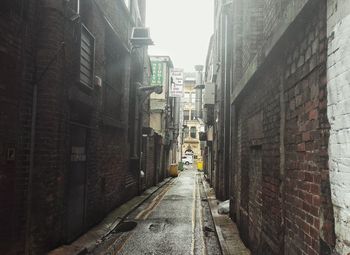 Alley amidst street in city