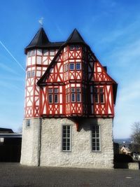 Low angle view of red house against sky