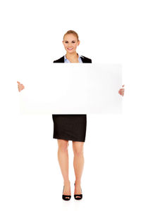 Portrait of woman standing against white background