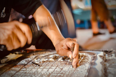 Midsection of man working on table