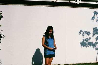 Young woman standing on palm tree