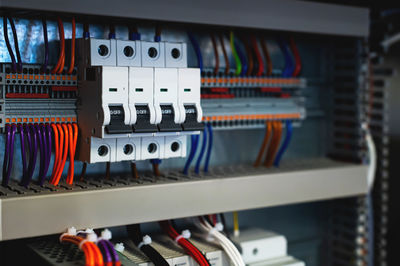 Several batch switches in an electrical control cabinet on a production line, surrounded by