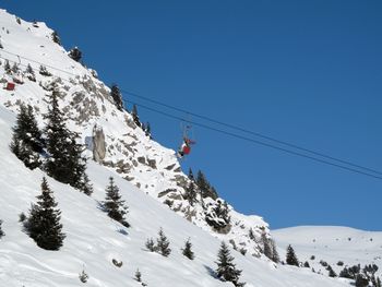 Low angle view of ski lift against clear sky