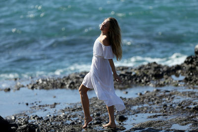 Full length of woman standing on beach