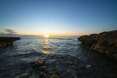 Scenic view of sea against sky during sunset