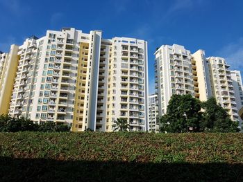 Low angle view of buildings against blue sky