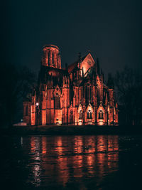 Illuminated church against clear sky at night