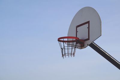 Low angle view of basketball hoop against blue sky