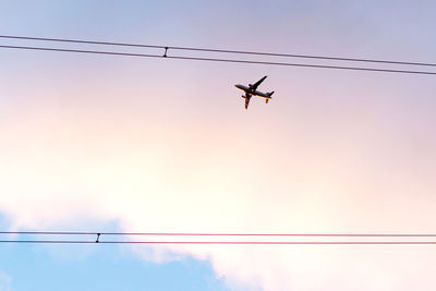 Low angle view of airplane flying in sky