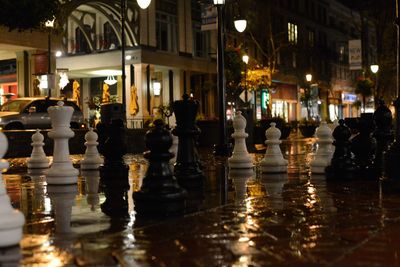 Chess pieces on city street at night