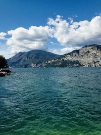 Scenic view of sea and mountains against sky