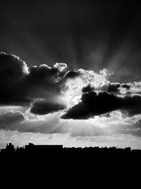 Low angle view of silhouette trees on field against sky