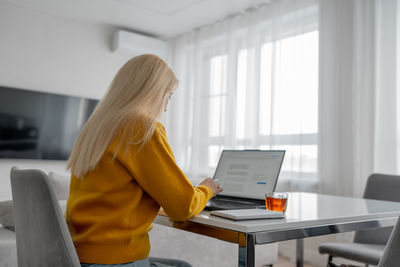 Woman using laptop at home