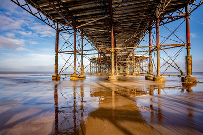 Underneath the wooden boardwalk of a victorian pier